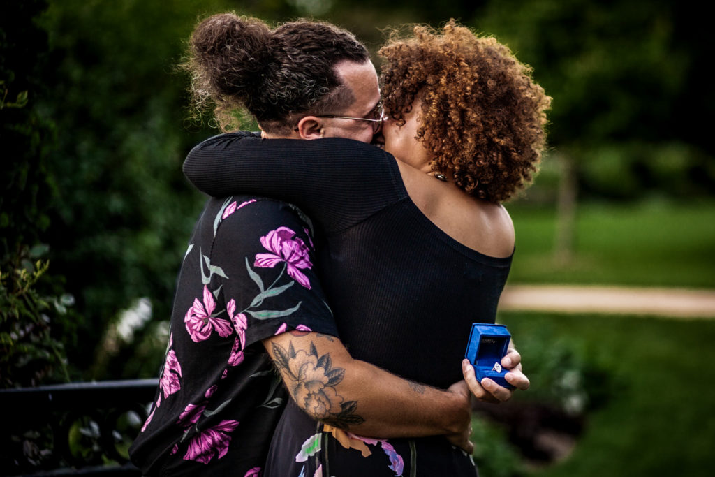 proposal moment between couple surrounded by greenery