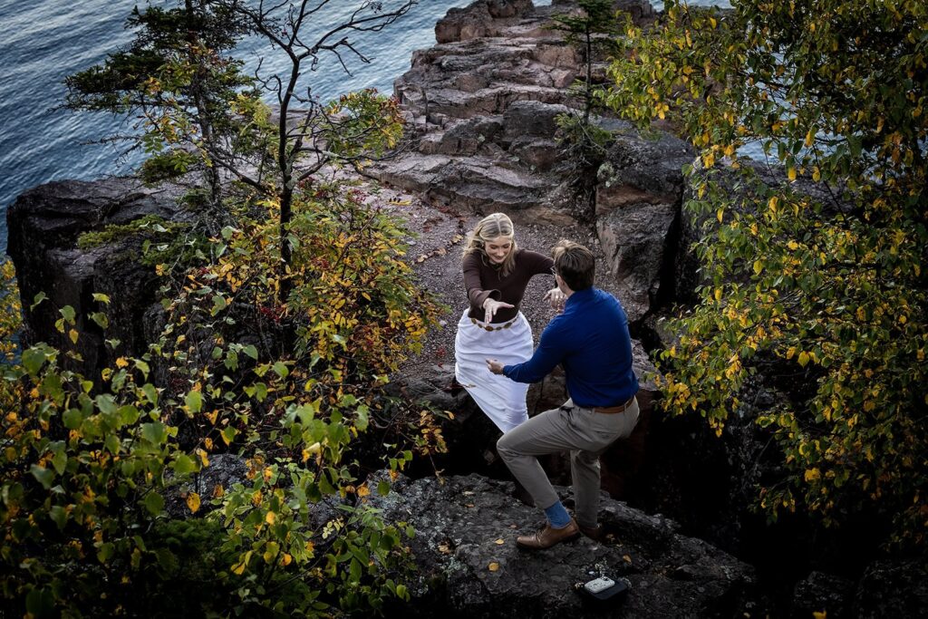 Dramatic cliffside engagement photography at Palisade Head, North Shore