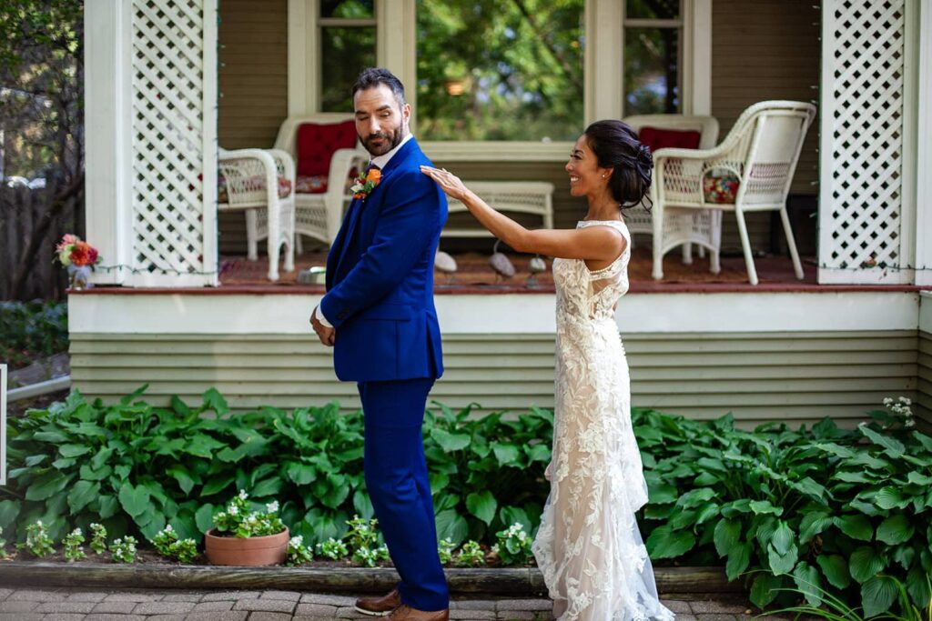 bride and groom sharing their first look at this backyard wedding in minnesota