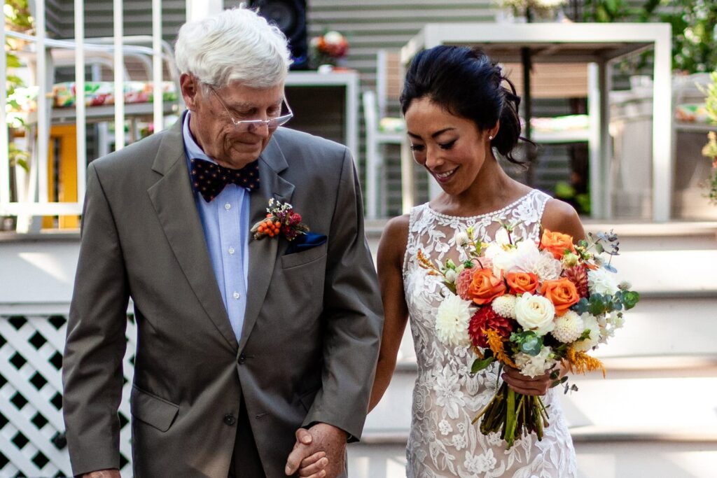 bride walking down the aisle at backyard wedding in st paul