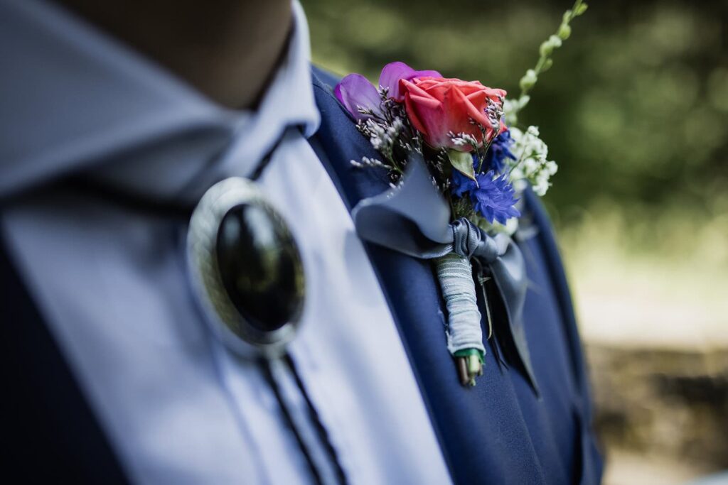 colorful boutonniere for groom during portland wedding