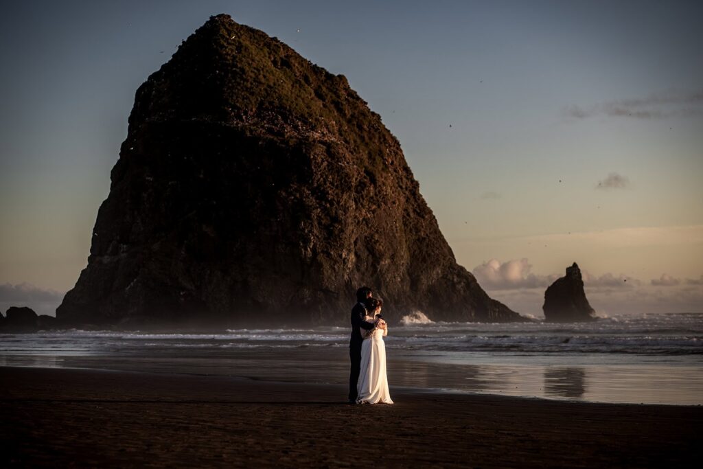 bride and groom portraits on Cannon Beach in Oregon after hoyt arboretum wedding