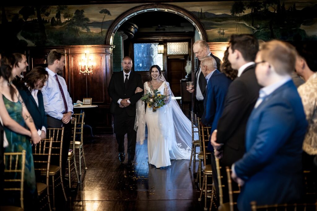 bride walking down the aisle during wedding ceremony in minnesota