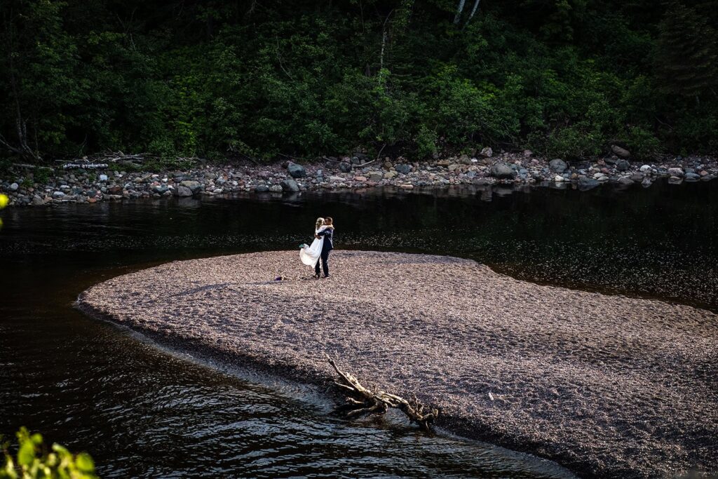 Adventurous Minnesota elopement photography featuring a couple exploring the shoreline.