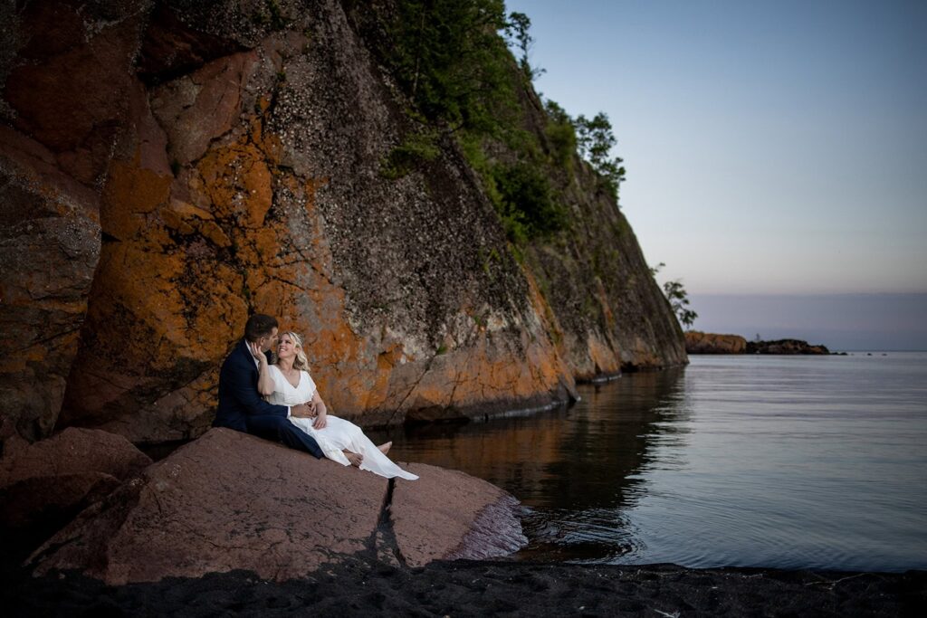 couple on black sand beach for north shore proposal