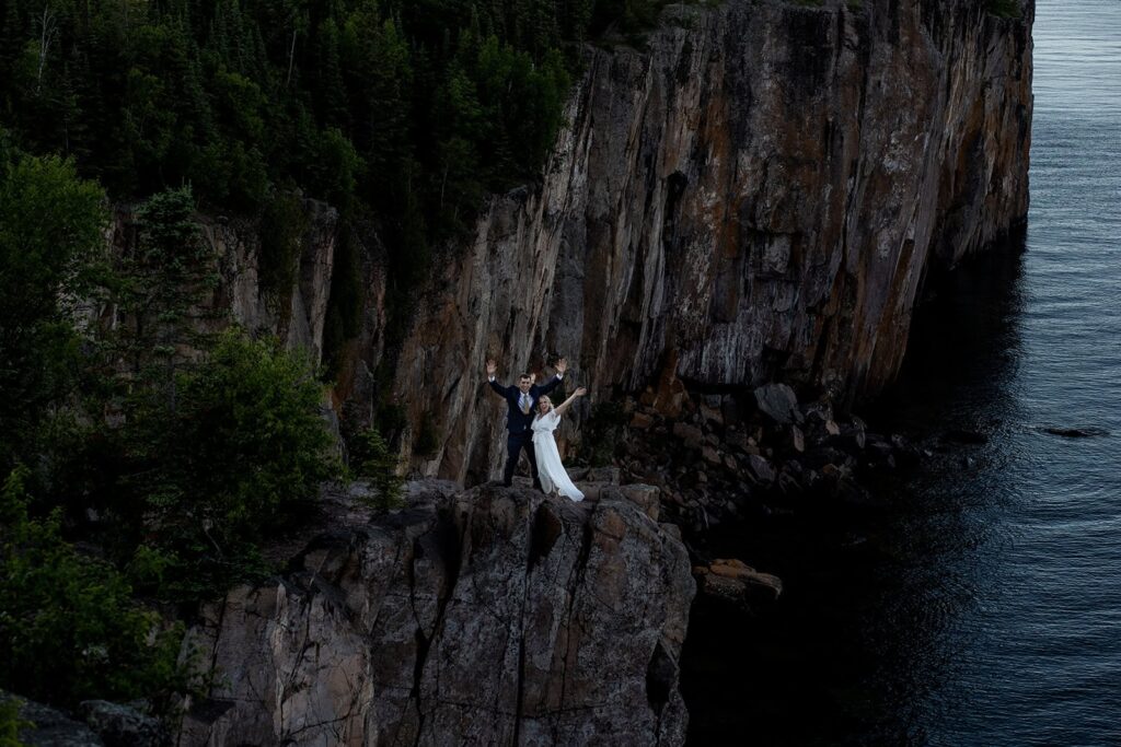 Fun portrait taken by a Minnesota elopement photographer at a lakeside overlook.