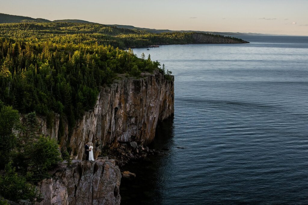 Minnesota elopement photographer taking portraits of a couple on the North Shore cliffs.