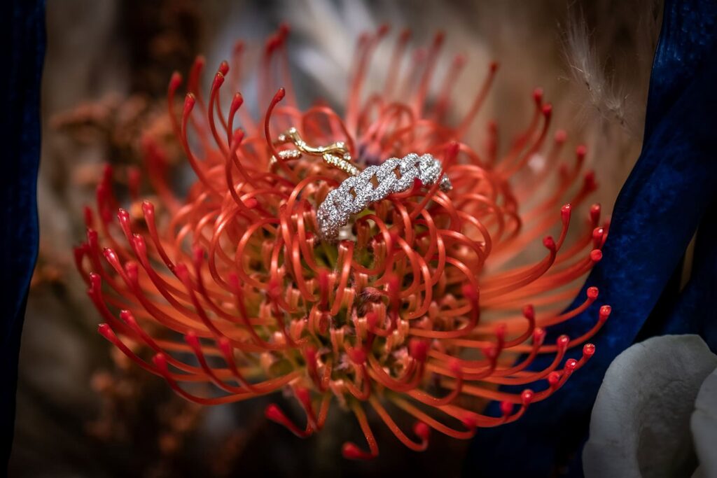 Close-up of fall-inspired bridal bouquet with rings placed on top.