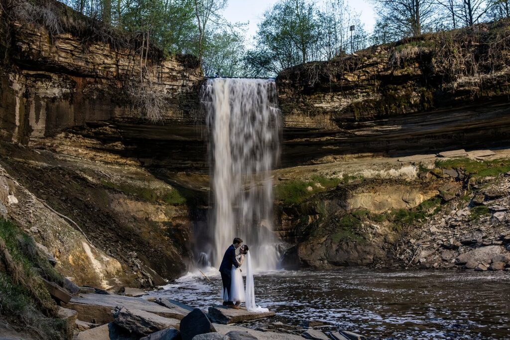 dramatic portrait of the bride and groom at Minnehaha Falls