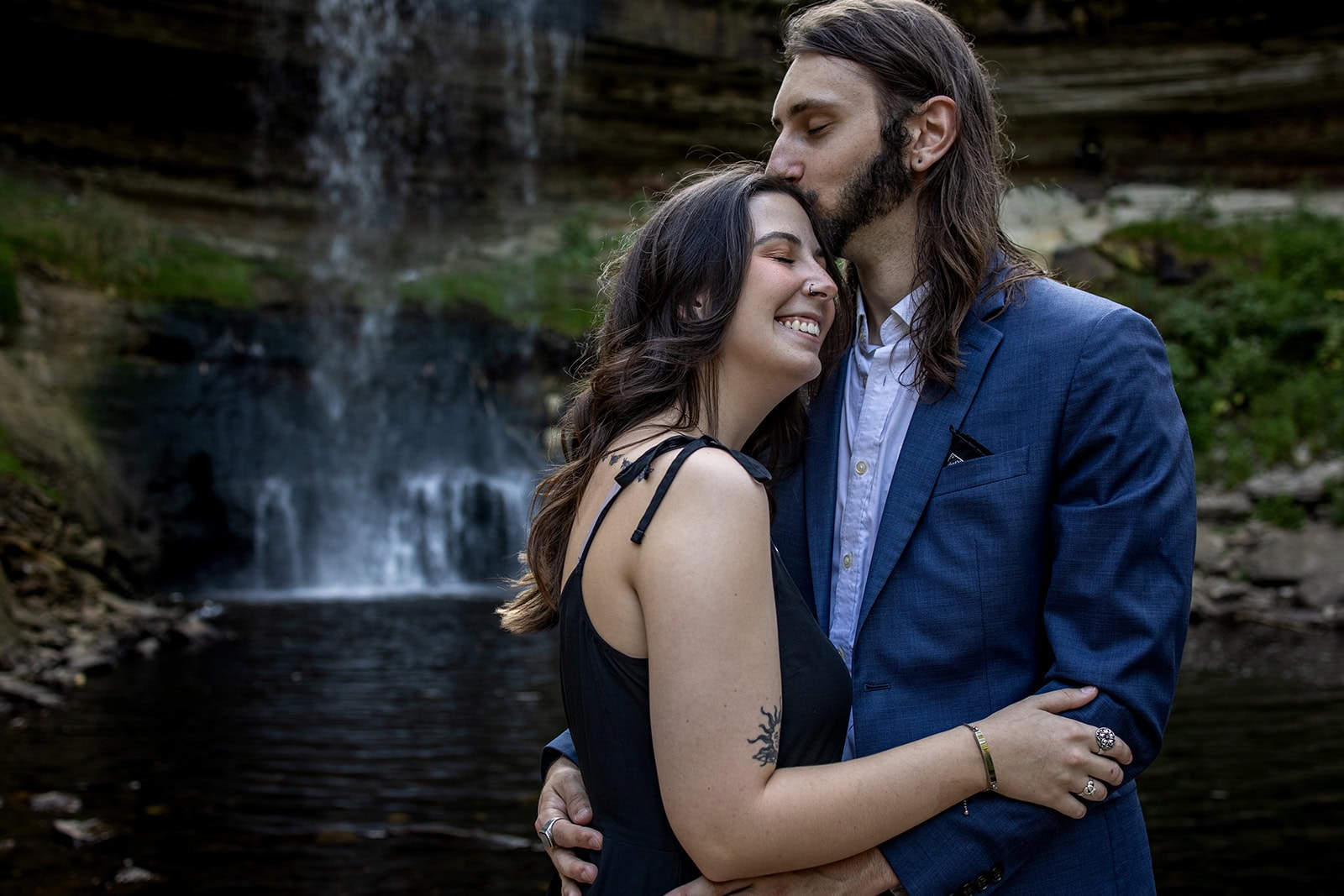 Engagement portraits at Minnehaha Falls with lush August greenery
