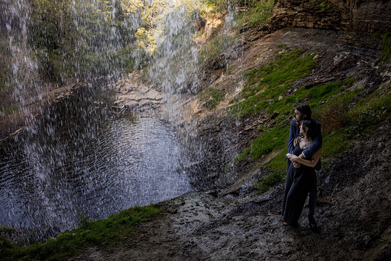 Couple standing near the waterfall at Minnehaha Park in summer