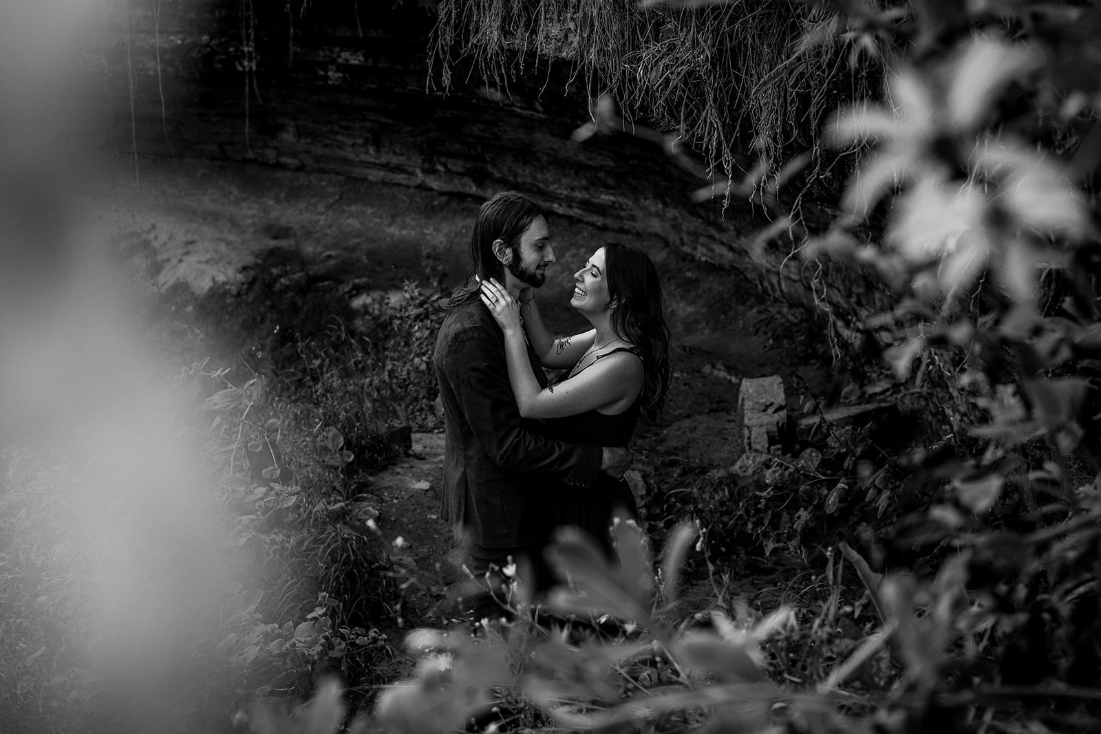Candid engagement photo of couple laughing at Minnehaha Falls Minneapolis