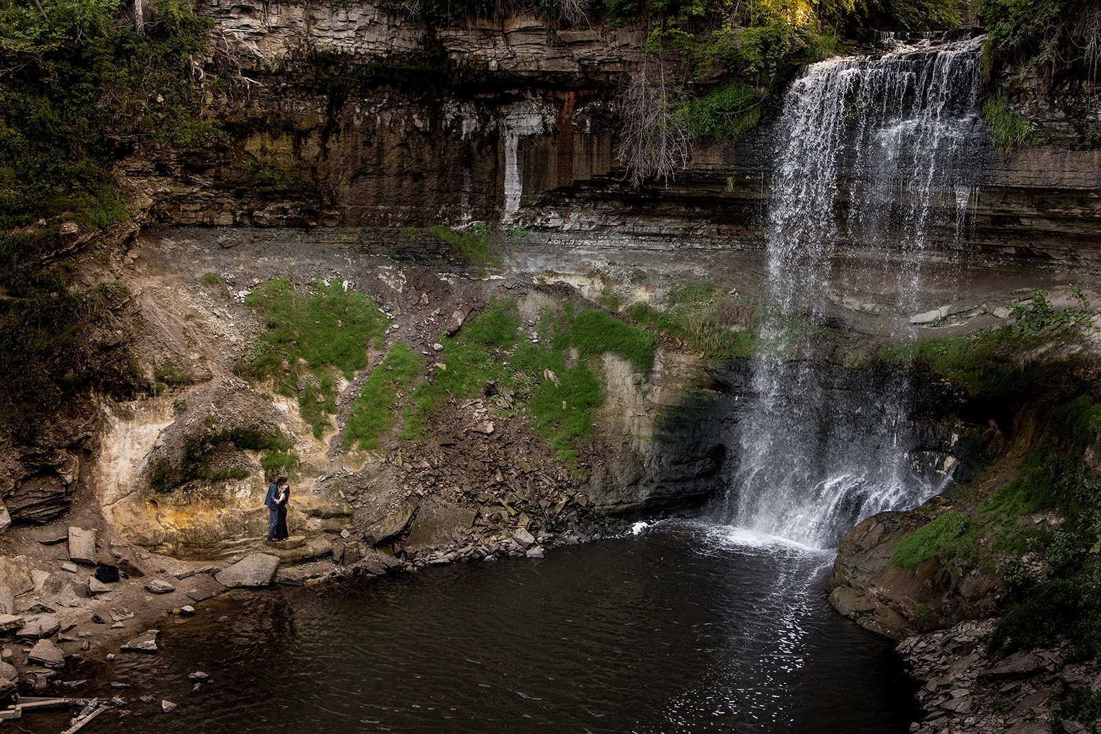 Couple gazing at each other with the waterfall in the background