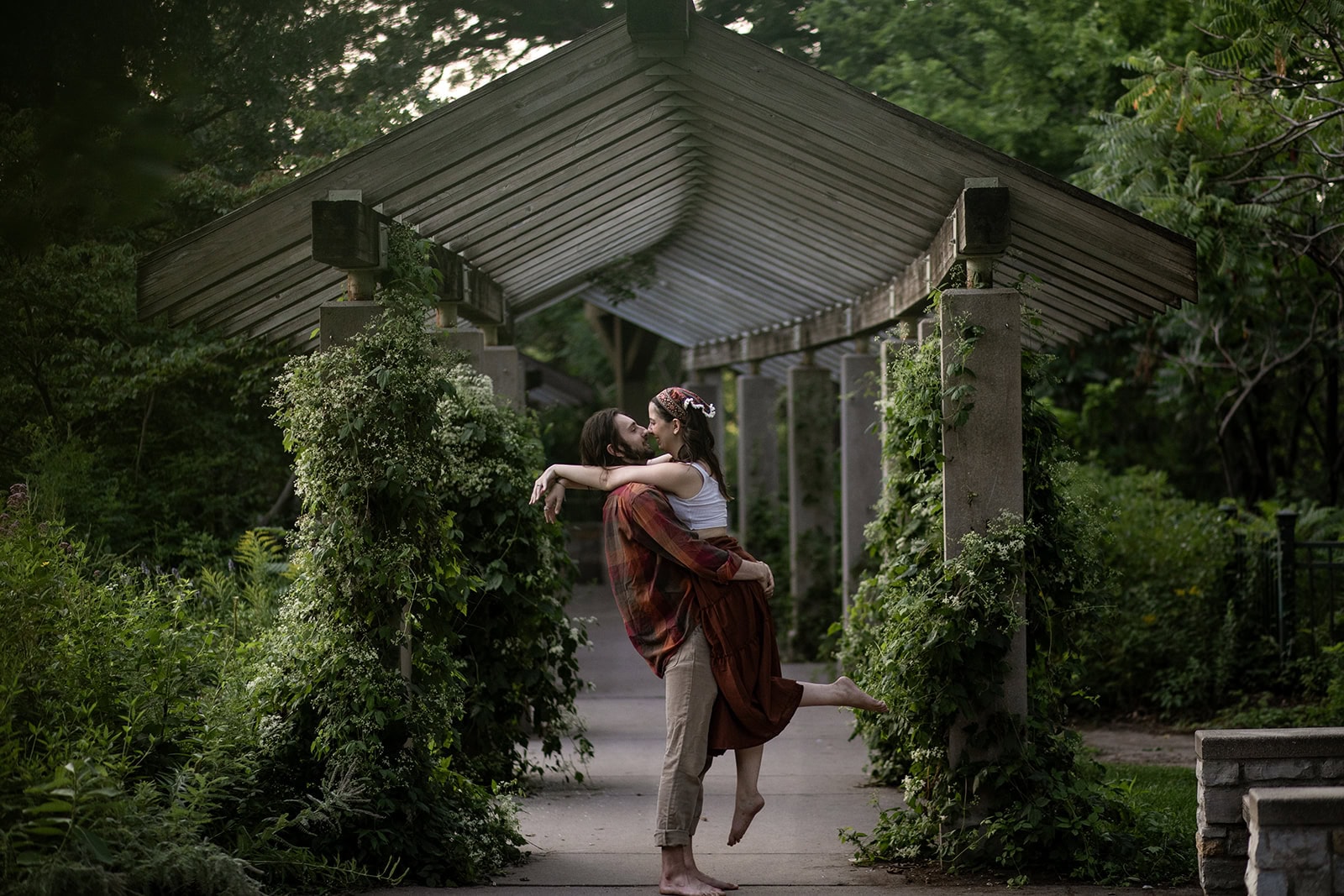 Isaac twirling Jessica on the wooded paths of Minnehaha Park