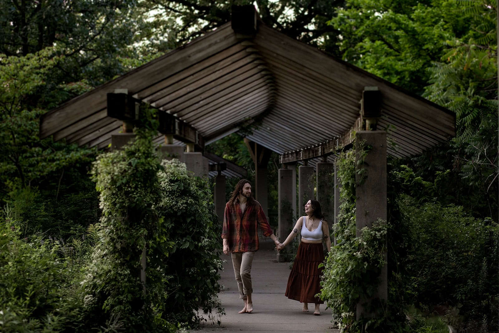 Jessica and Isaac exploring the park paths during their August engagement session