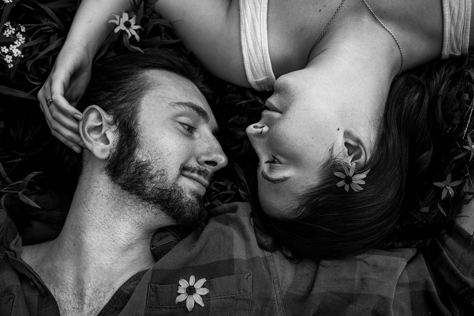 Couple lying together on the grass near Minnehaha Falls in Minneapolis