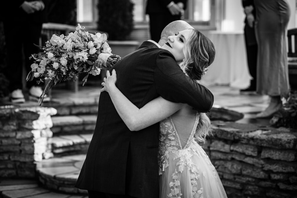 Bride sharing a moment with her father before wedding ceremony