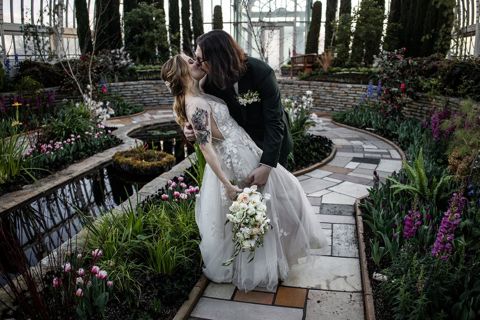 Groom dipping bride after their Como Zoo Conservatory wedding ceremony in St. Paul