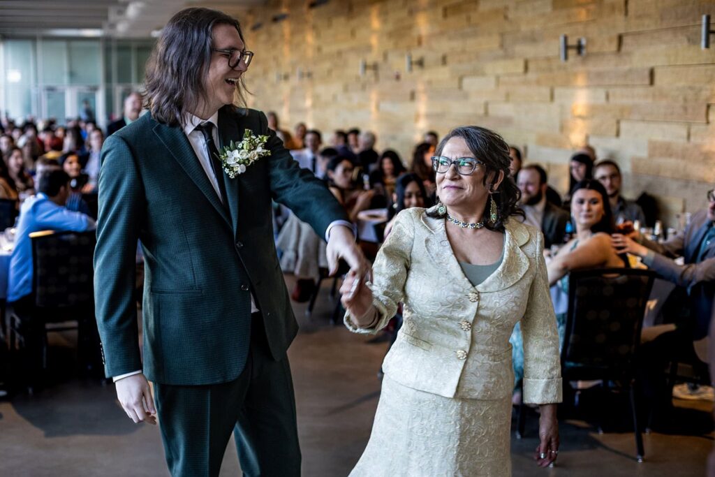 groom dancing with family member during como zoo wedding reception