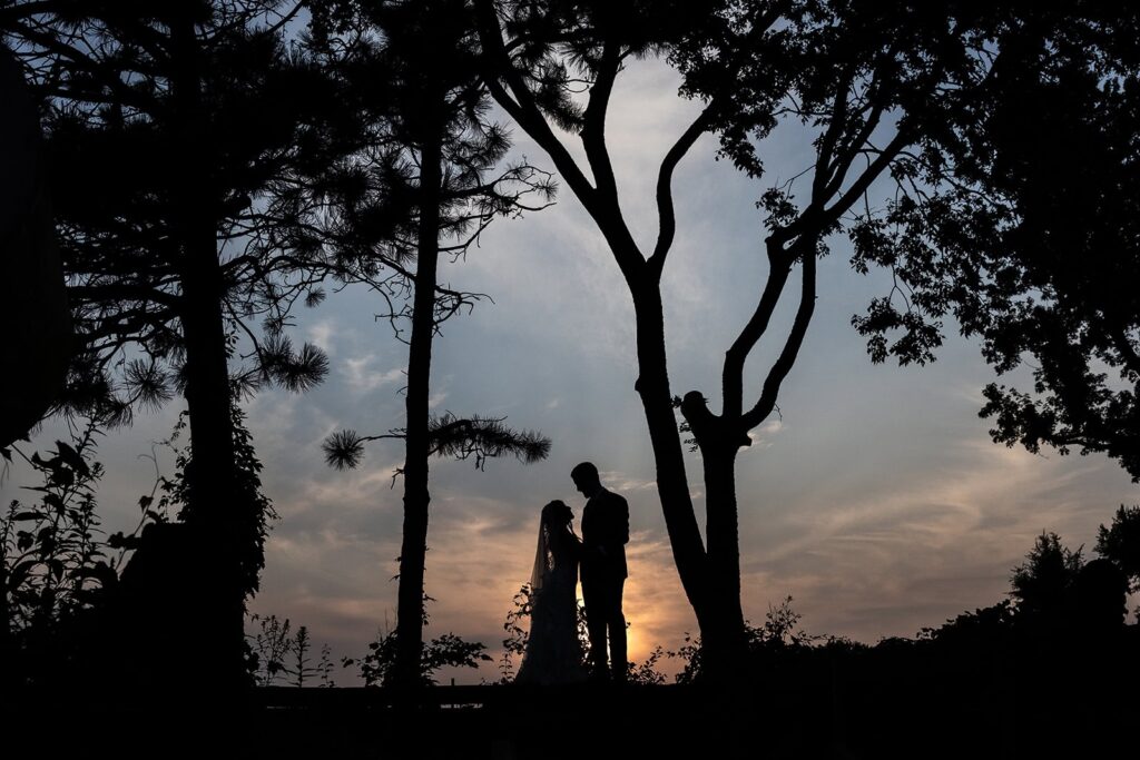 Golden hour portrait of bride and groom at Gardens of Castle Rock wedding
