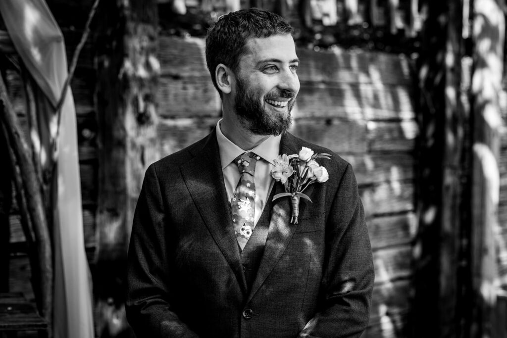 Groom watching his bride walk down the aisle on their wedding day