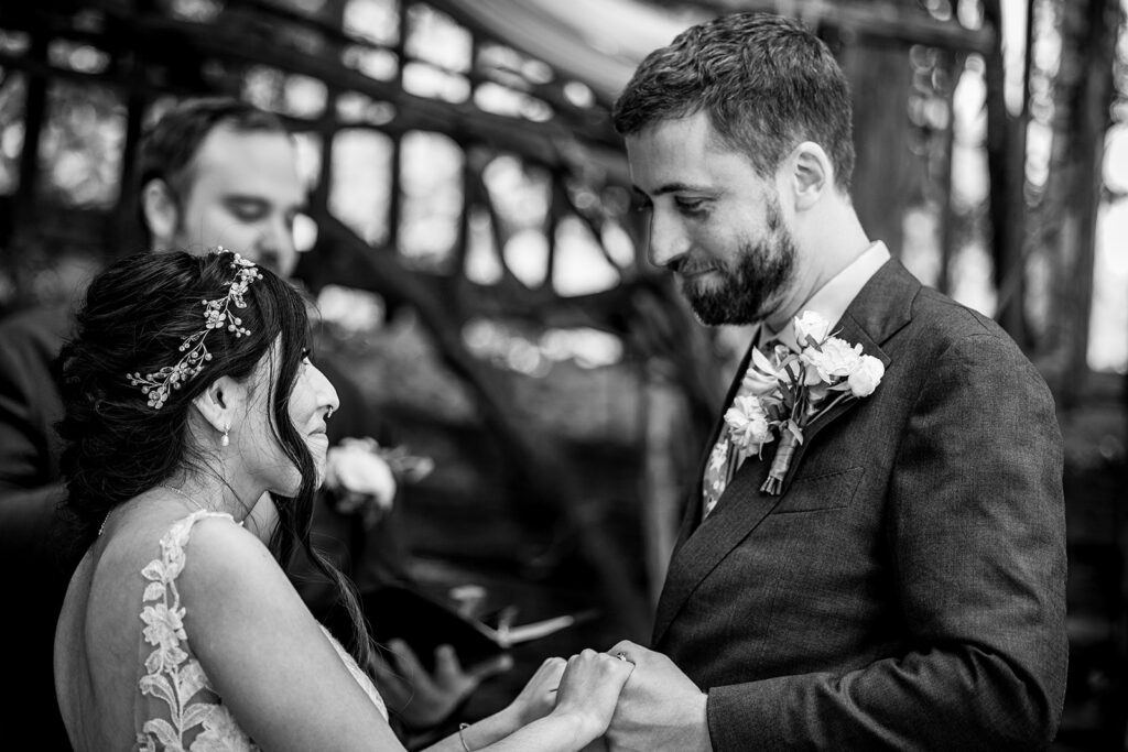 Close up of bride and groom holding hands during their wedding ceremony