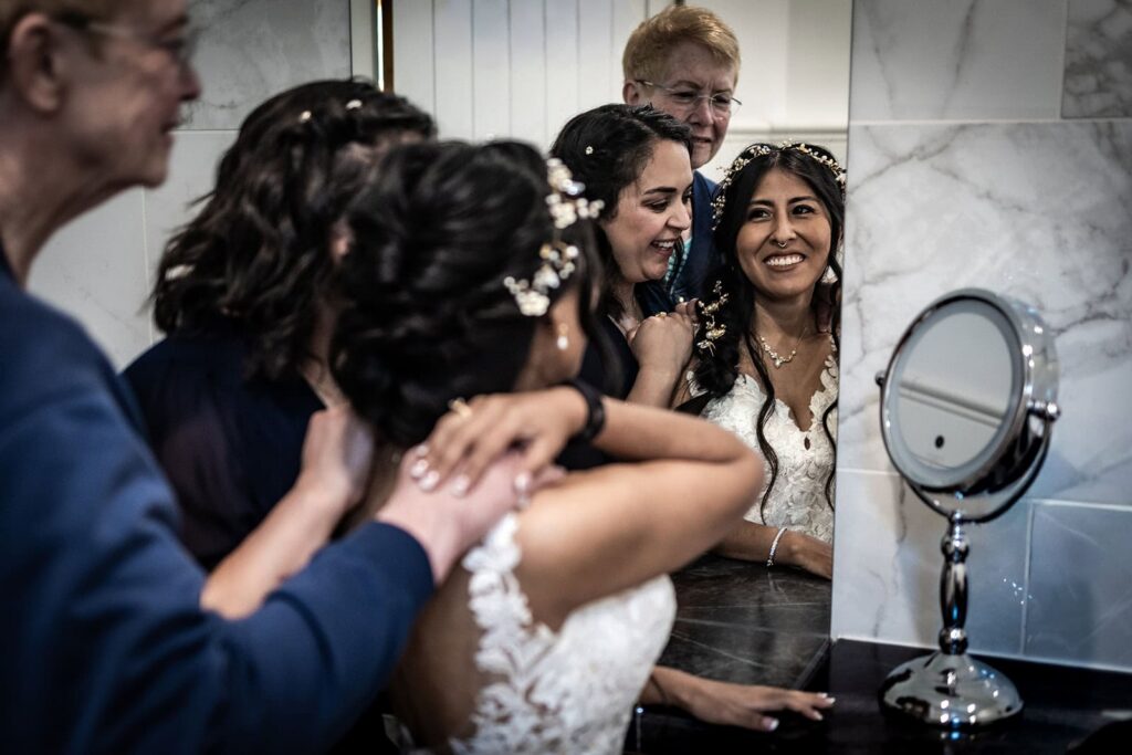 bride getting ready with loved ones during gardens of castle rock wedding day