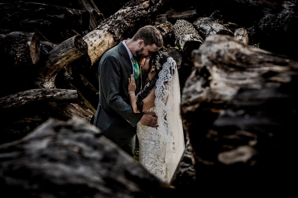 gardens of castle rock wedding portraits surrounded by chopped up logs