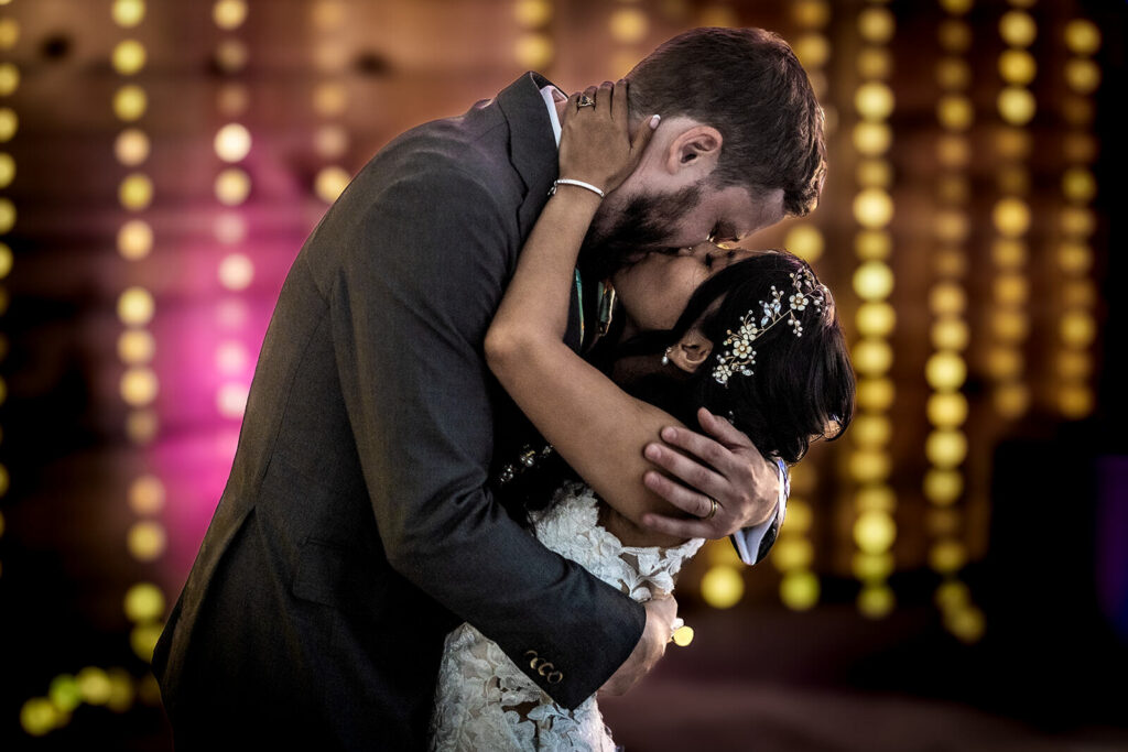 bride and groom dancing surrounded by fairy lights during gardens of castle rock wedding