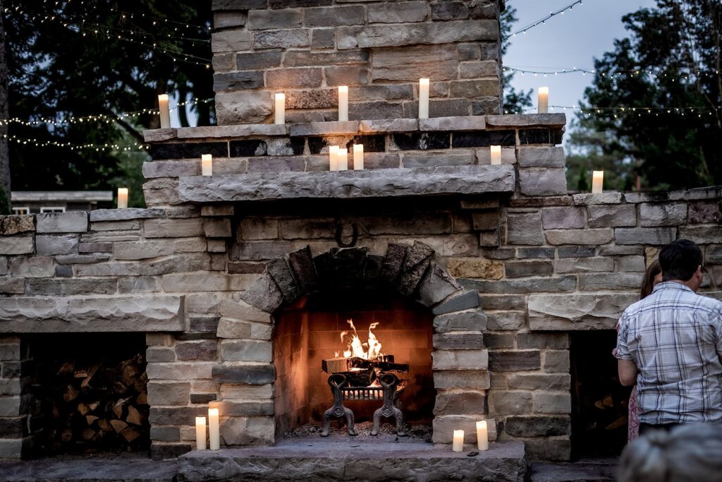 grand outdoor fireplace at gardens of castle rock wedding venue