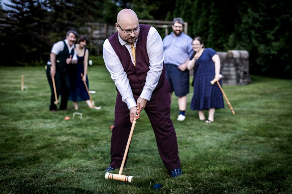 guests playing garden games during minnesota summer wedding